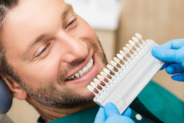 porcelain veneers_mature man at dentist_ocala dental care_pmon20210819 (1) Porcelain Veneers